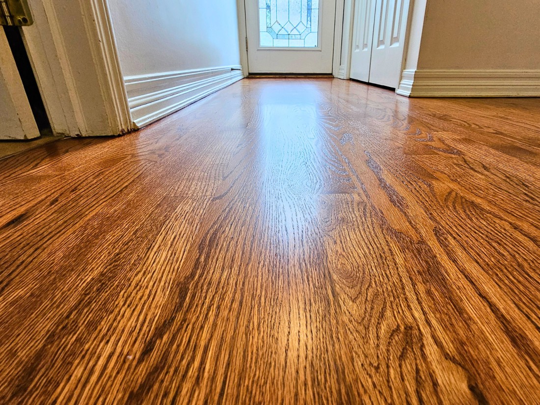 Newly refinished red oak floors with a brown stain and water based finish, located in St. Joseph Michigan.